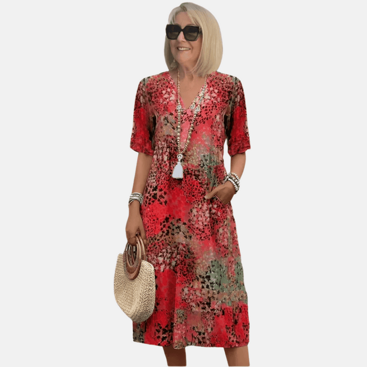 Dames losse vintage zomerjurk met V-hals en korte mouw in A-lijn model, getoond op de rug