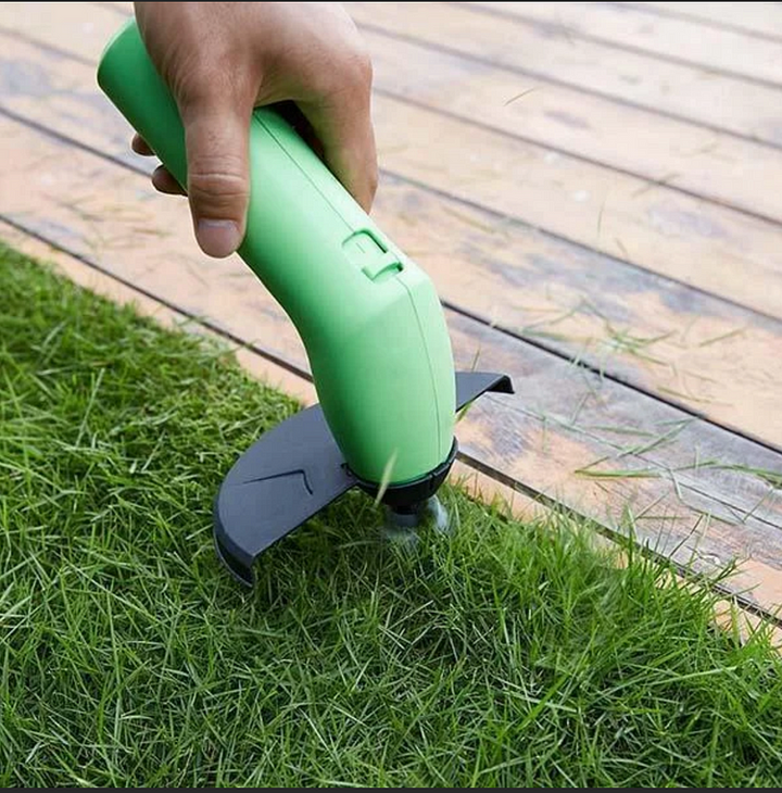 Overzicht van de groene Taavita draadloze mini grastrimmer en beschermkap