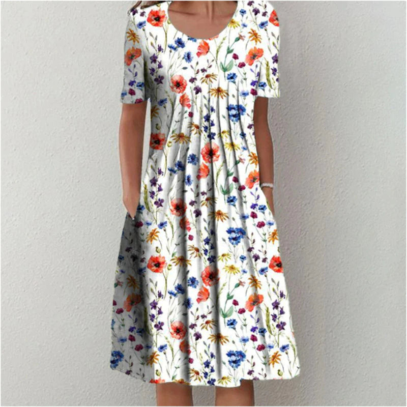 Luchtige dames zomerjurk met vrolijke bloemenprint, comfortabele v-hals en handige zakken. Ideale midi jurk.