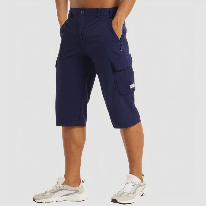 Man draagt donkerblauwe sneldrogende cargo shorts van voorzijde
