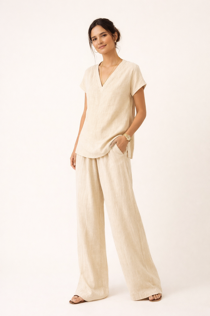 Model in lichtbeige casual tweedelige set toont losse pasvorm van blouse en broek, ideaal voor comfort.