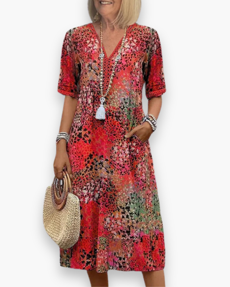 Dames midi-jurk met levendige bloemenprint, V-hals en zakken voor een casual zomerlook. Comfortabel en elegant.