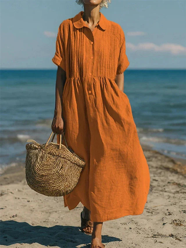 Comfortabel oranje hemdblusenkleed met een klassieke kraag, geschikt voor diverse lente- en zomergelegenheden.