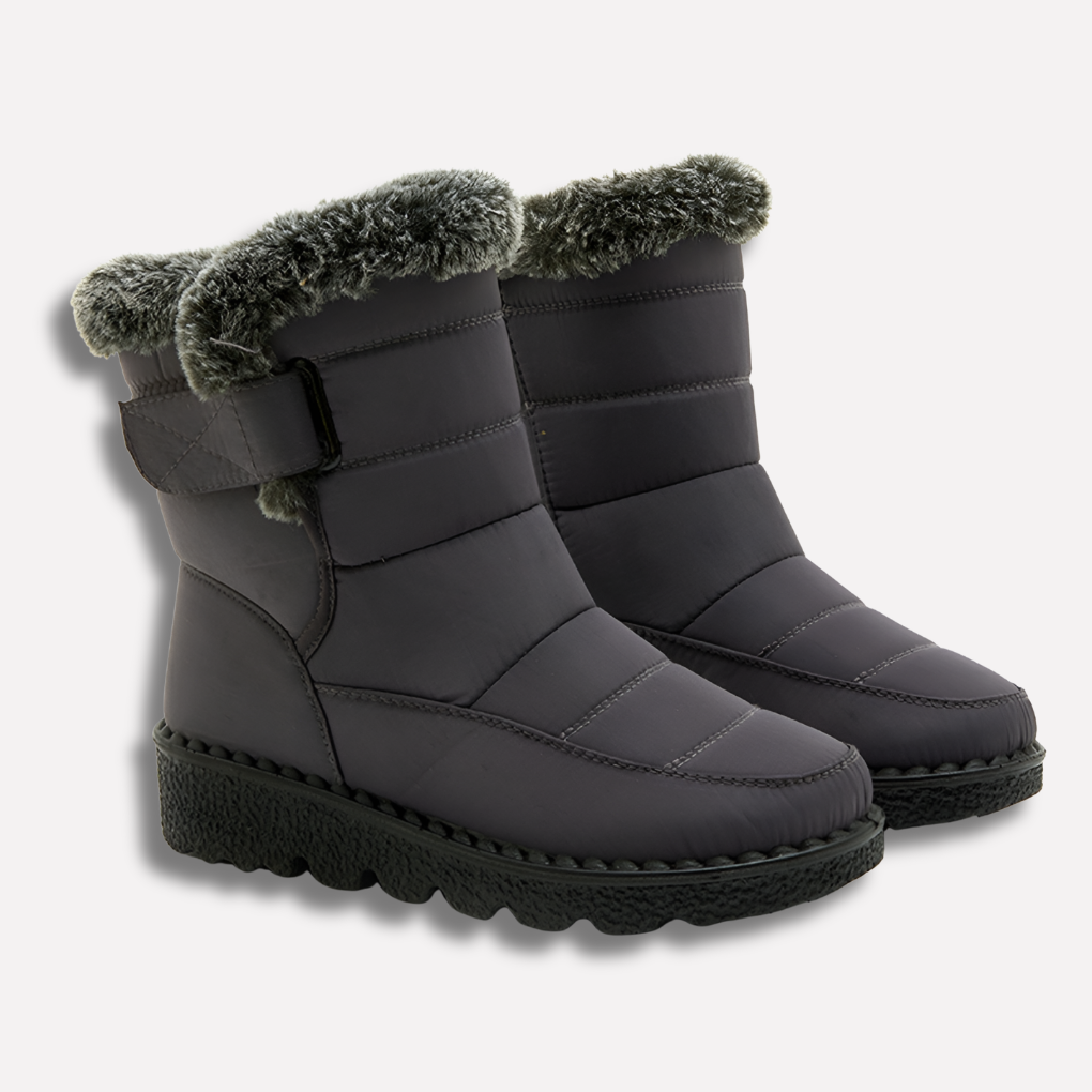 Grijs zwarte waterdichte winterlaarzen voor dames in de sneeuw