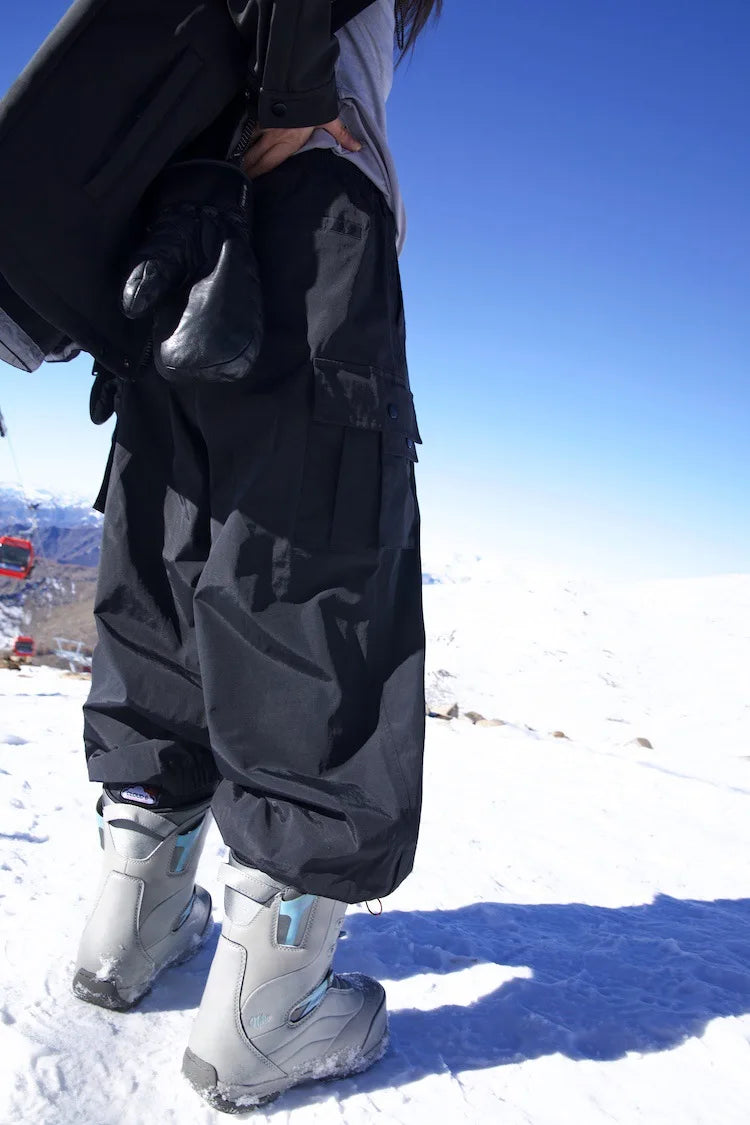 Comfortabele zwarte baggy skibroek, unisex en warm, essentieel voor dames en heren wintersport outfits.