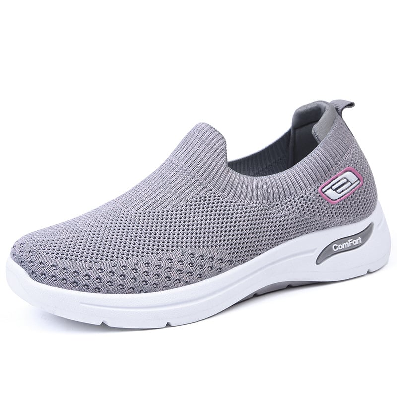 Zijkant van de roze sneaker met dempende zool.