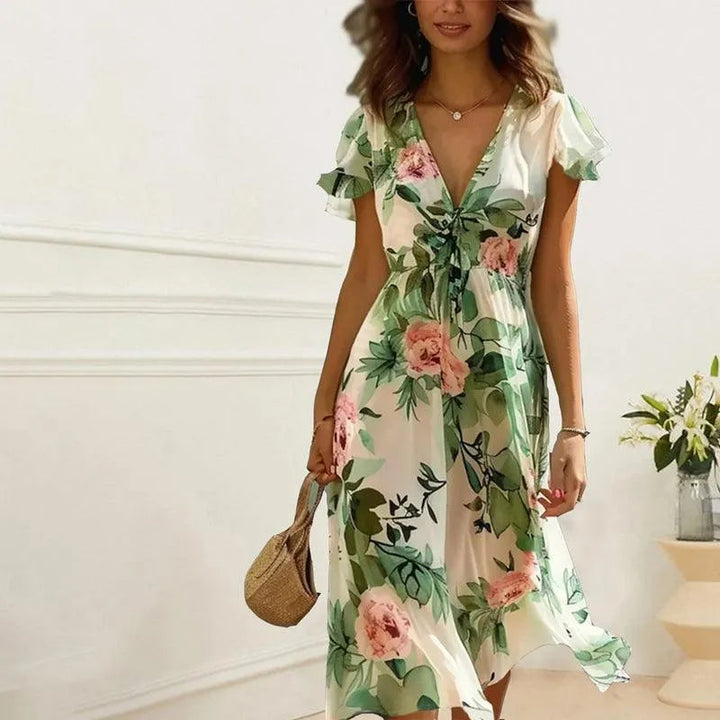 Stijlvolle beige midi jurk voor dames met bloemenprint en diepe V-hals, ideaal voor casual of feestelijke gelegenheden.