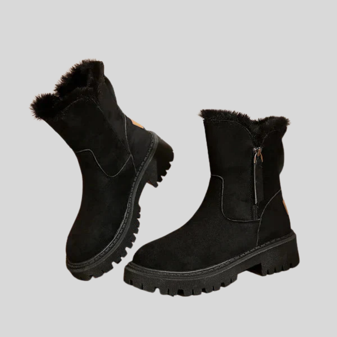 Zwarte dames winterlaarzen met zijrits, thermisch gevoerd en gripzool voor warme voeten en stabiliteit.