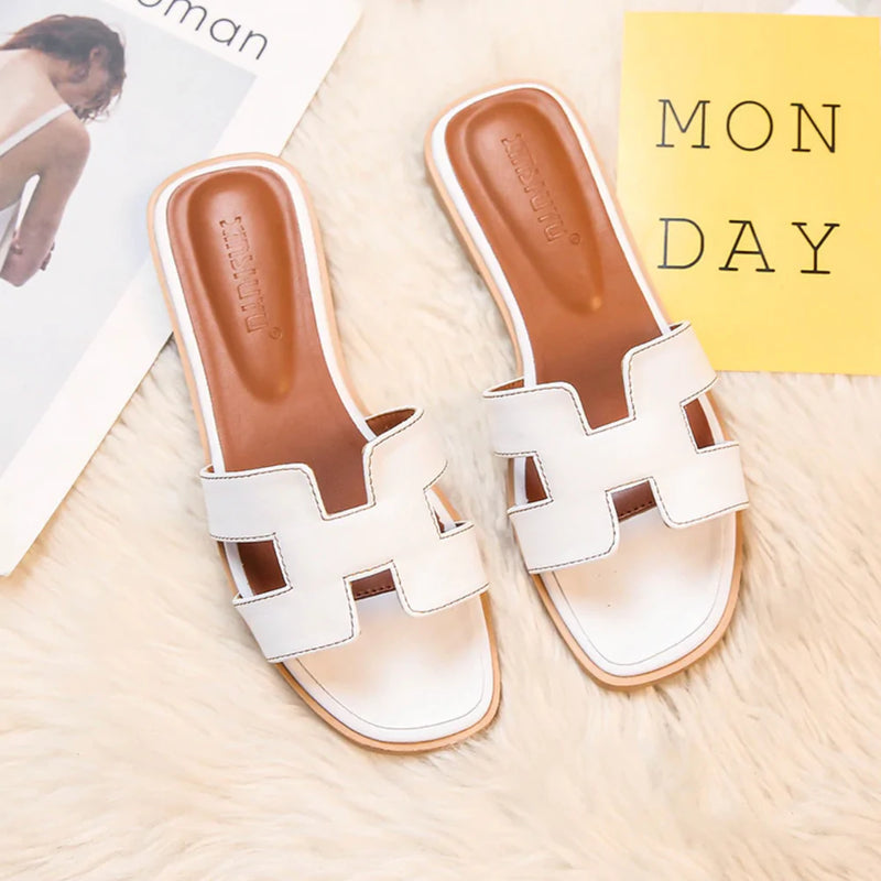 Comfortabele Jenelles H-slipper voor dames in elegant zwart, perfect voor zomerse dagen en vrije tijd.