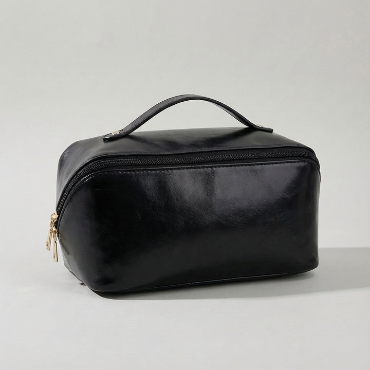 Compact dames toilettasje Glambox, een essentieel reisaccessoire voor georganiseerde make-up.