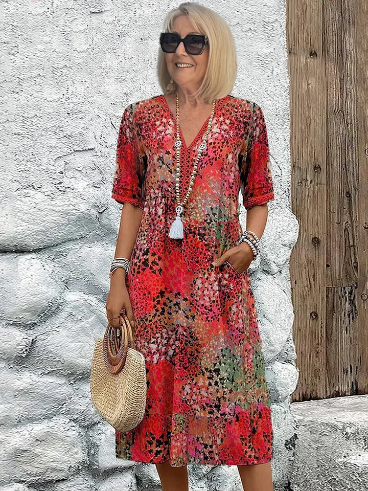 Elegante dames midi jurk, A-lijn model, V-hals, met kleurrijke bloemenprint. Perfecte feestjurk.