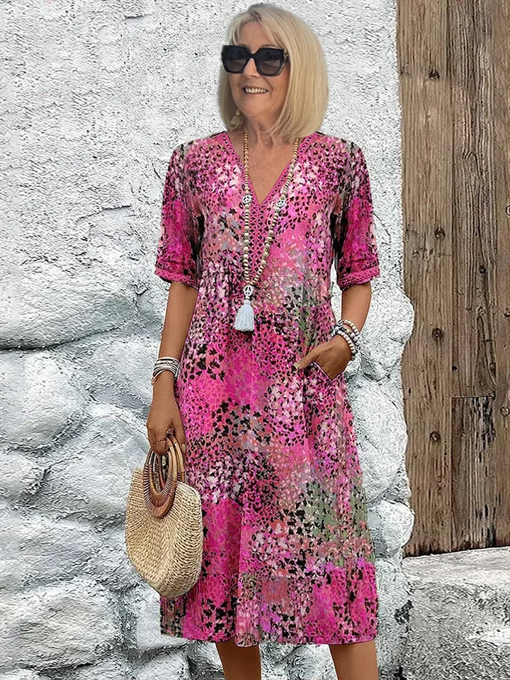 Dames midi jurk met prachtige bloemenprint en flatterende A-lijn pasvorm. Stijlvolle V-hals voor een elegante look.