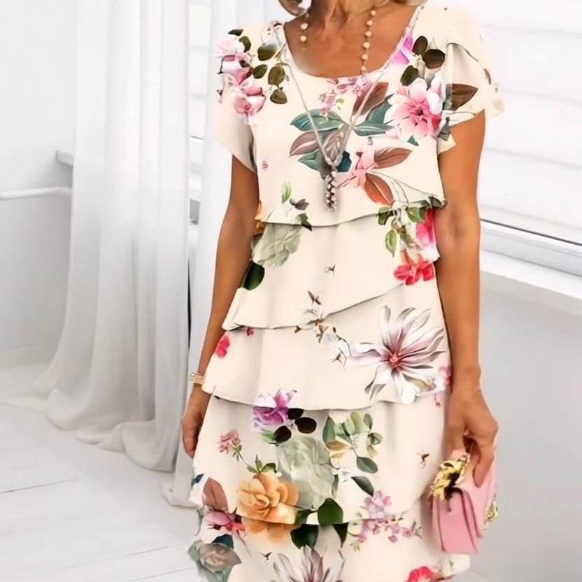 Leona bloemen watervaljurk, een stijlvolle dames zomerjurk geschikt voor zowel casual als elegante outfits.