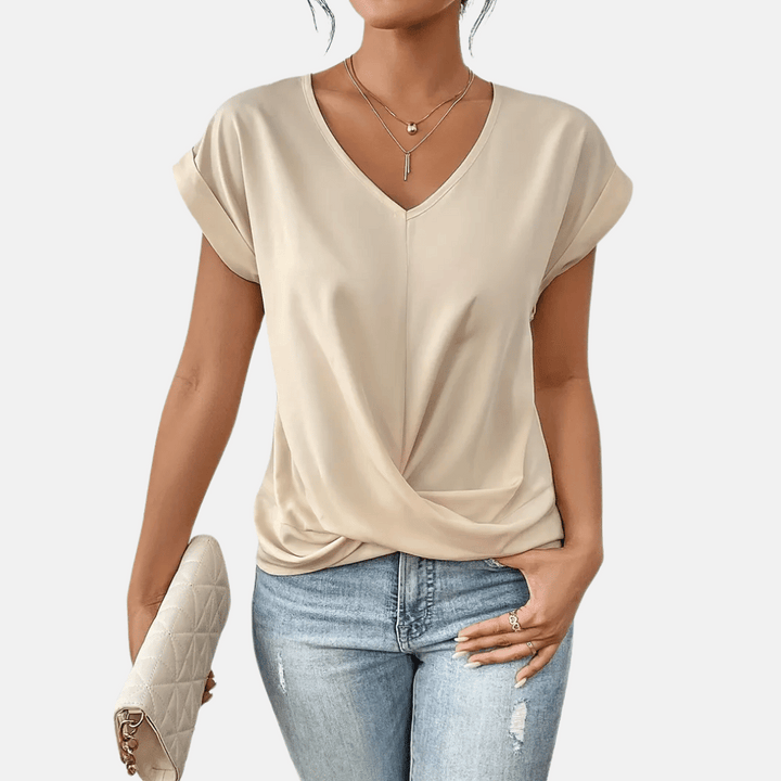 Dames blouse met elegante V-hals en gedrapeerde zoom, perfect voor een modieuze lentelook.