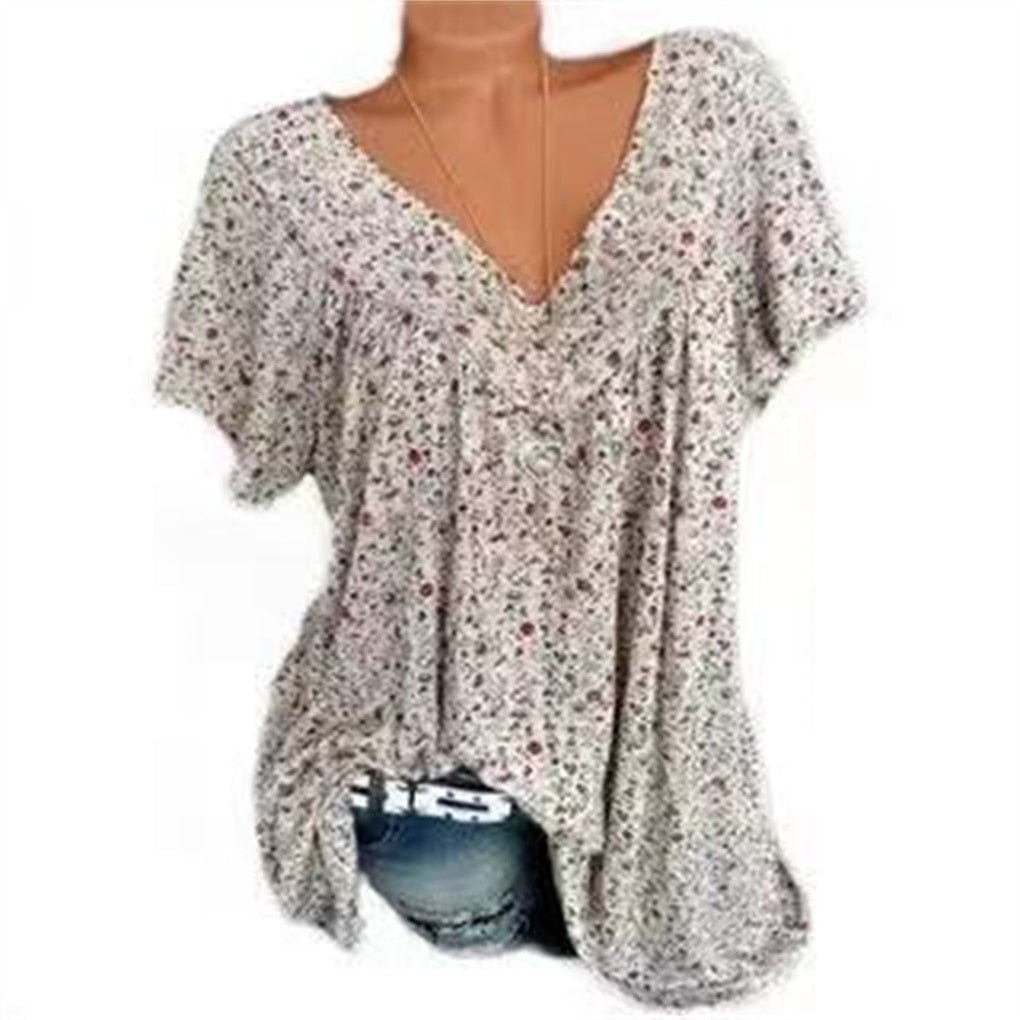 Elegante dames strandblouse met bloemenprint en korte mouwen, perfect voor je vakantie.