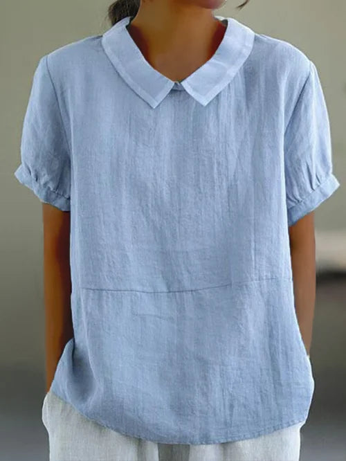 Dames elegante blouse met klassieke Peter Pan kraag en trendy pofmouwen. Perfect voor een zomerse casual-chique look.