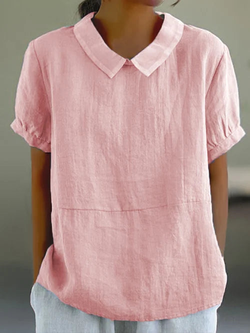 Stijlvolle dames top met charmante Peter Pan kraag en elegante pofmouwen. Modieus en veelzijdig voor de zomer.