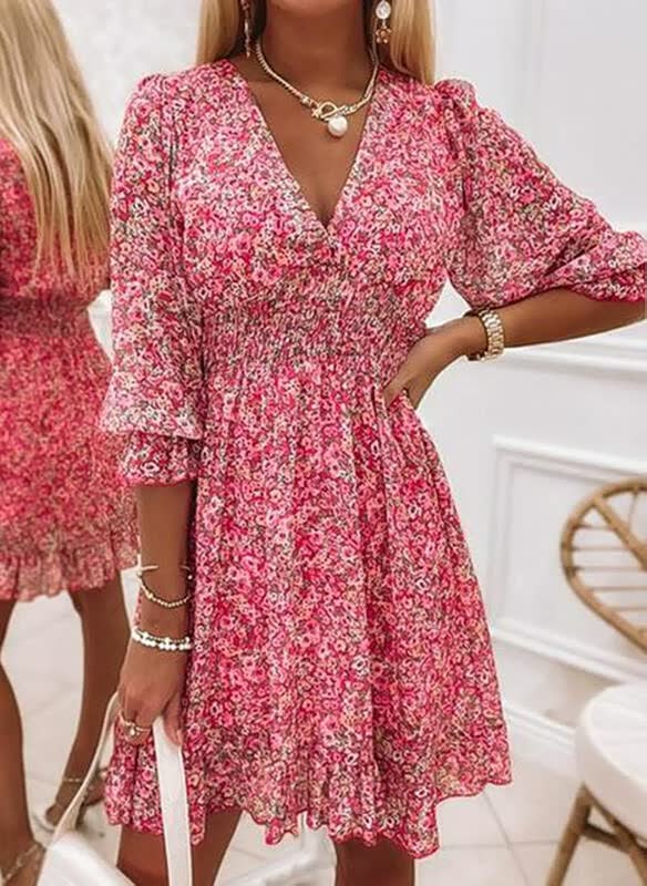 Prachtige gebloemde mini jurk met lange lantaarnmouwen en diepe V-hals voor een elegante en zomerse look.