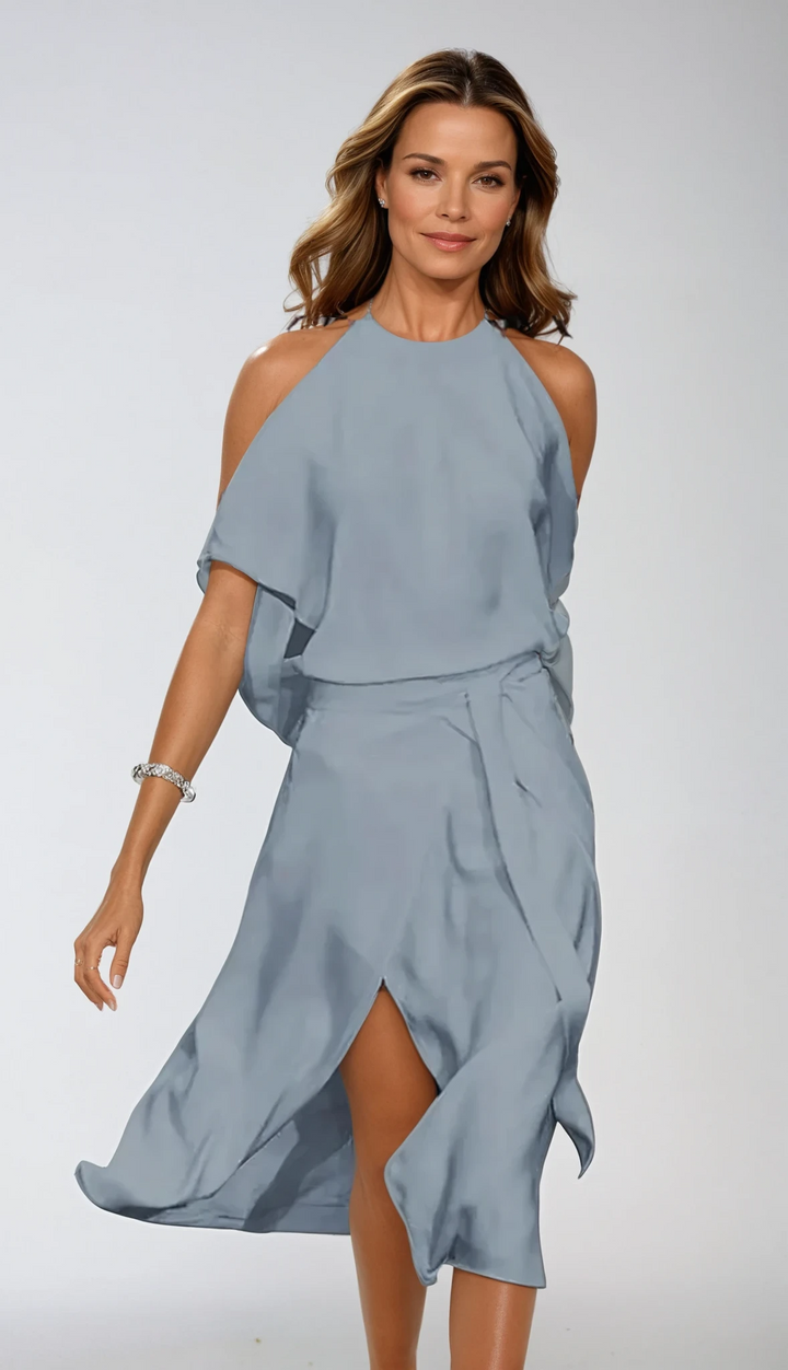 Stijlvolle dames halter midijurk met open schouders, asymmetrische zoom en een feestelijke look.