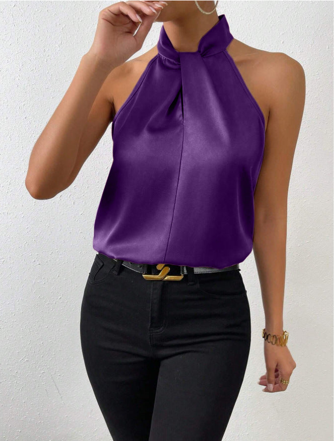 Donkerblauwe elegante top, mouwloos en met gedraaide kraag, ideaal voor een avondje uit.