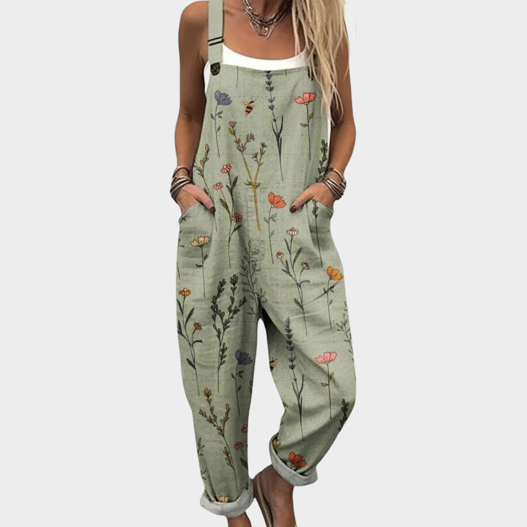 Detailopname van de groene dames jumpsuit met botanisch motief en handige zijzakken