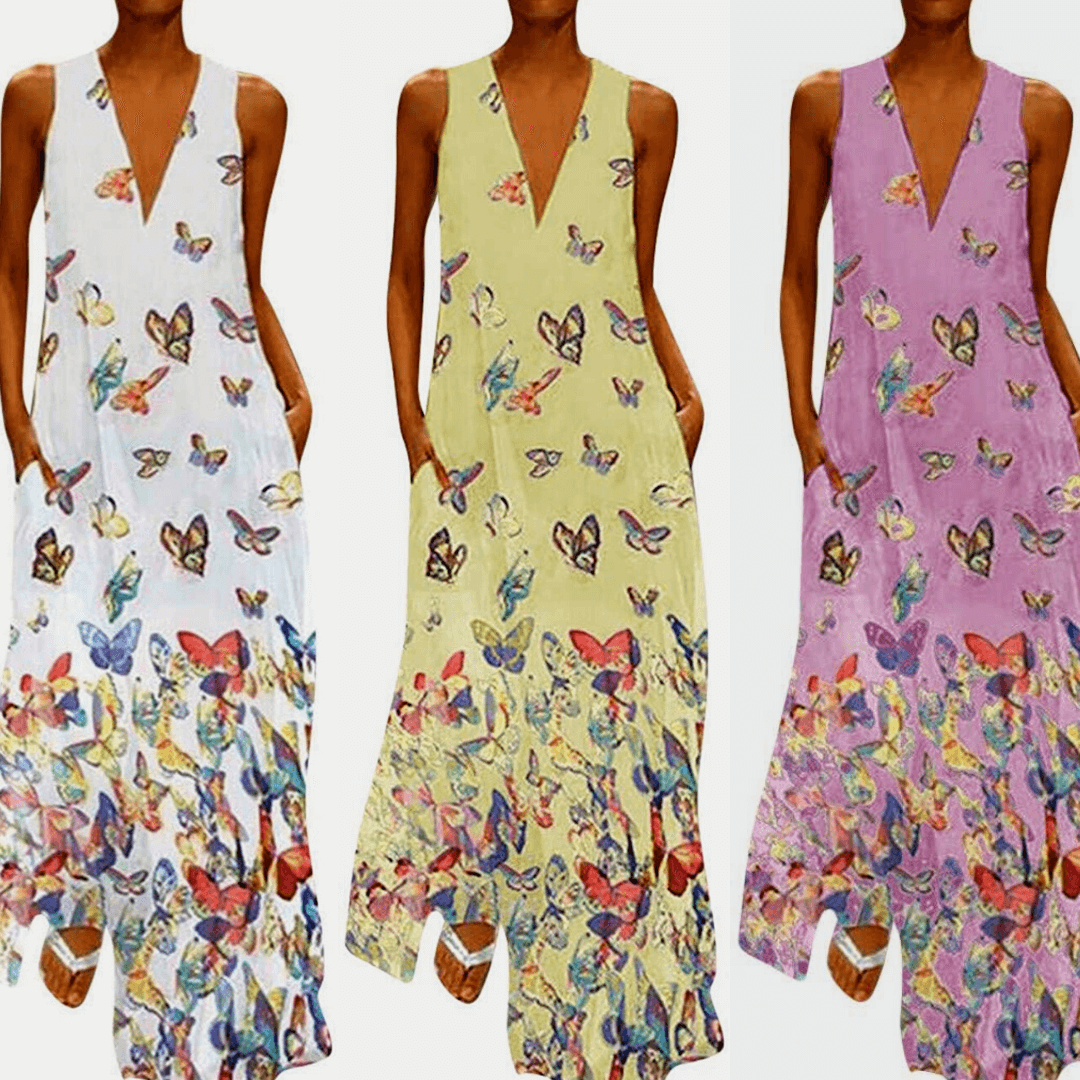 Malia mouwloze maxi zomerjurk met vrolijk vlinderpatroon. Ideaal als lange strandjurk voor dames.