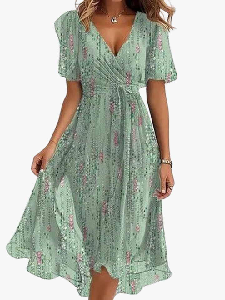 Dames midi jurk met vrolijke bloemenprint, elegante v-hals en zwierige vlindermouwen. Perfect voor zomer en feest.