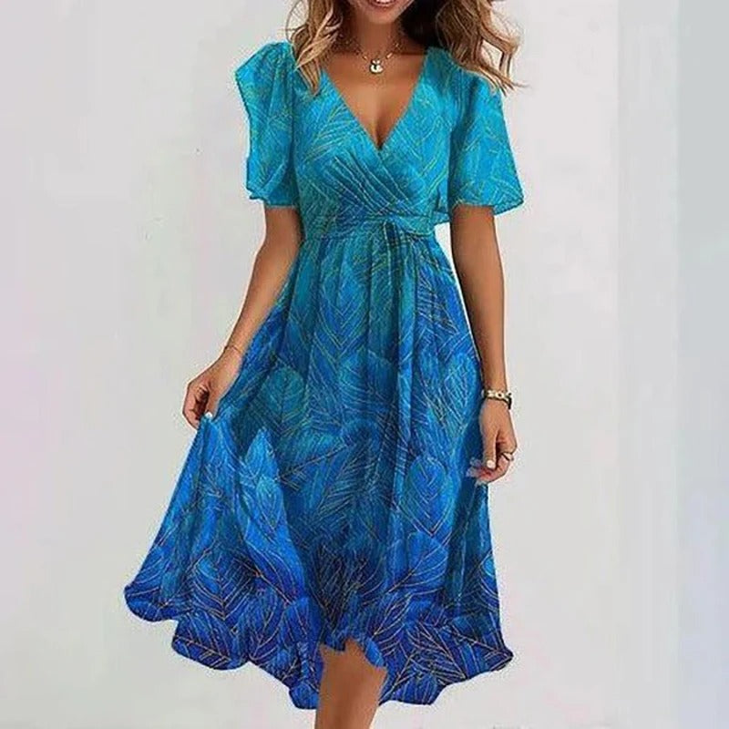 Elegante zomerse midi jurk met frisse bloemenprint, comfortabele v-hals en luchtige vlindermouwen. Perfect voor dames.
