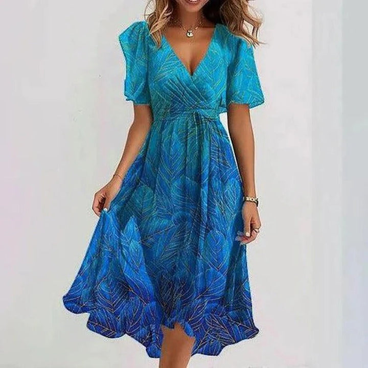 Elegante zomerse midi jurk met frisse bloemenprint, comfortabele v-hals en luchtige vlindermouwen. Perfect voor dames.