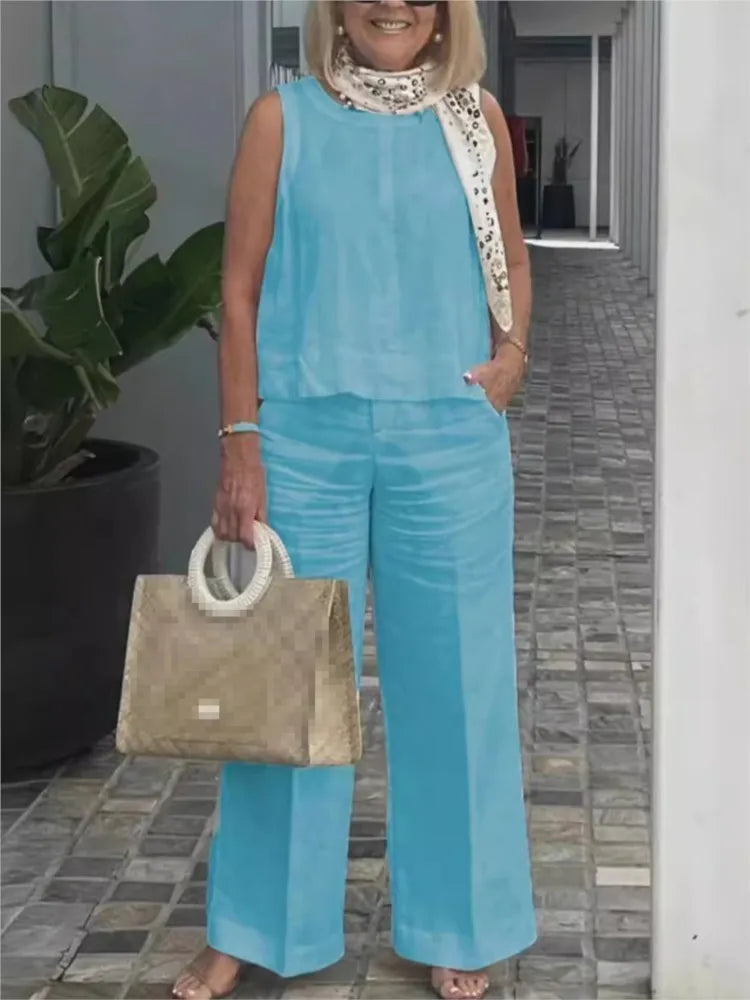 Elegante casual dames zomerset: mouwloze linnen blouse en wijde broek, perfect voor vakantiekleding.