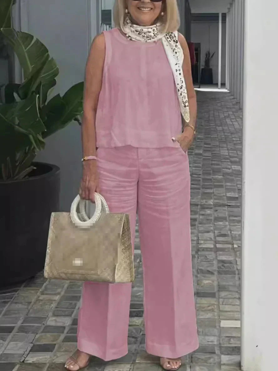 Luchtige dames zomerset: mouwloze blouse en comfortabele wijde linnen broek voor een complete zomeroutfit.