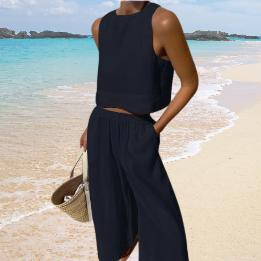 Stijlvolle dames zomeroutfit: mouwloze crop top en broek met brede pijpen. Een comfortabele tweedelige set.