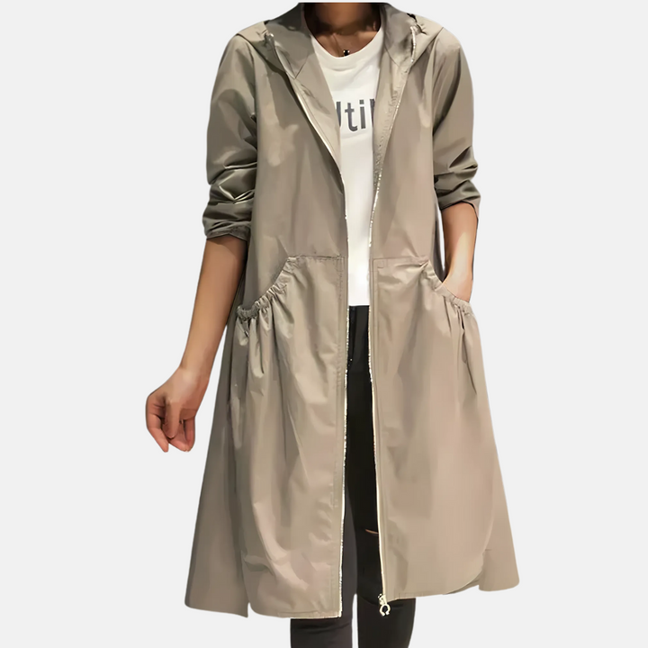 Dames waterdichte knielange regenjas met capuchon, ideaal voor bescherming tegen wind en regen.