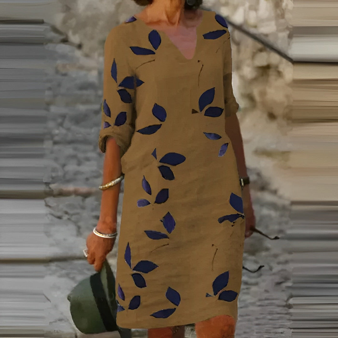 Dames zomerjurk met levendige bladerenprint, A-lijn pasvorm en elegante V-hals. Ideaal voor strand of vakantie.