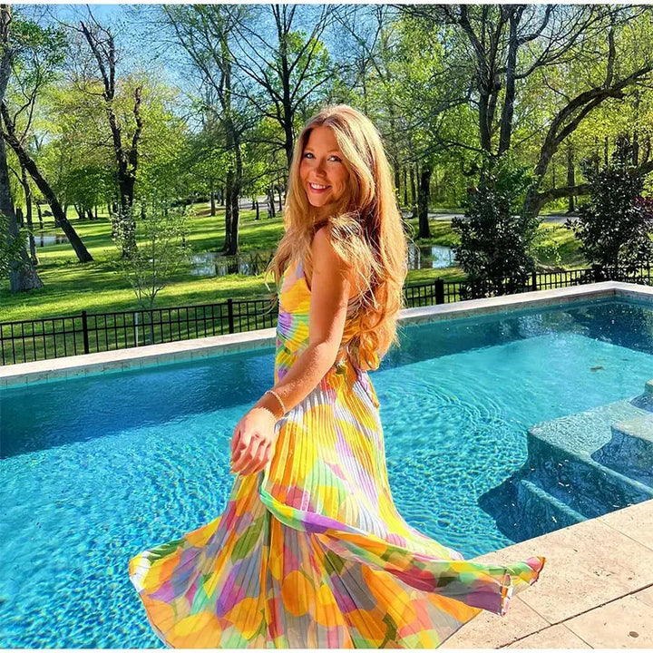 Elegante Vivienne zomerjurk voor dames met levendige bloemenprint, diepe halslijn en charmant strikdetail.