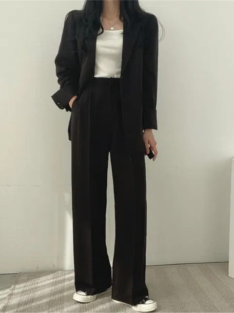 Tweedelig damespak, bestaande uit een stijlvolle blazer en een comfortabele pantalon. Ideaal voor zakelijke en casual looks.