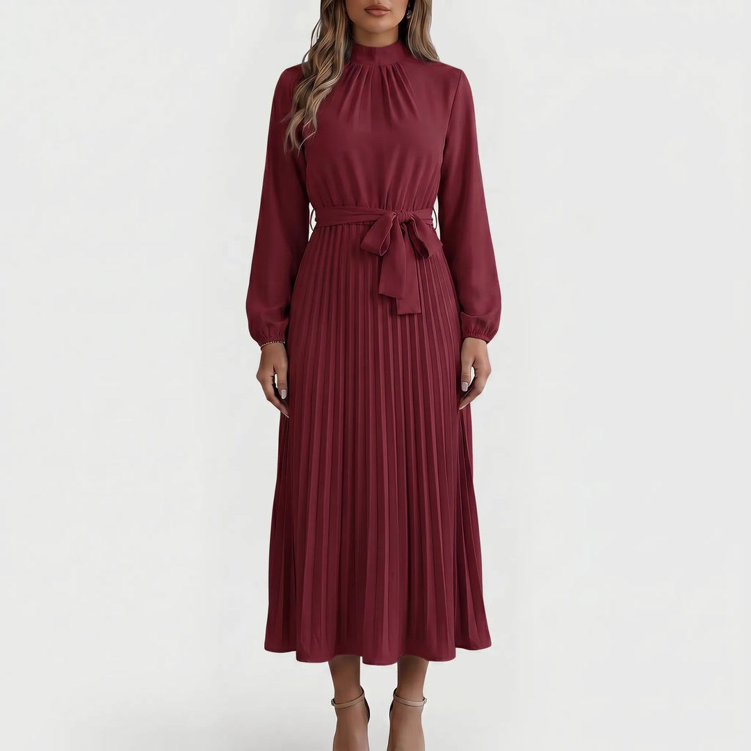 Formele dames plooimidi jurk met lange mouwen en strikceintuur, een veelzijdige en elegante keuze.