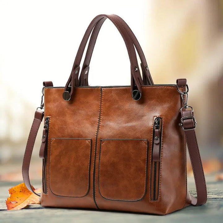"Elegante leren schoudertas met magnetische sluiting, duurzaam bruin leer, verstelbare riem voor draagcomfort."