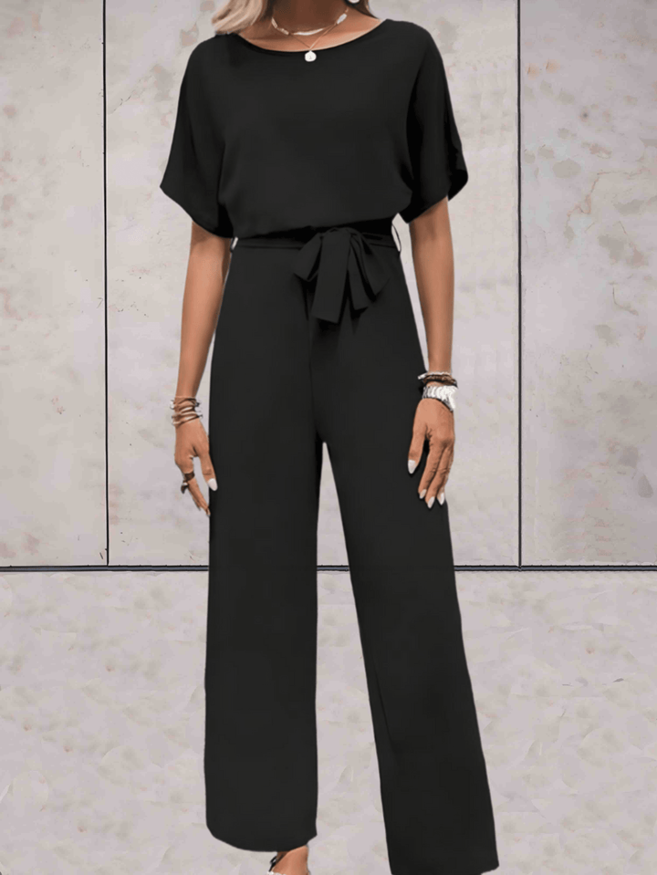 "Elegante Noa jumpsuit voor dames met wijde mouwen en striklinten, comfortabele luchtige stof, ideaal voor elke gelegenheid."
