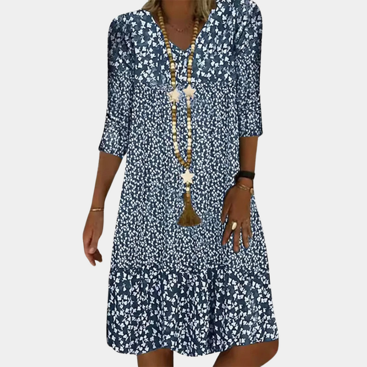 "Elegante Ottilie midi zomerjurk voor dames met V-hals, verfijnde pasvorm, ademende stof en levendige kleuren."