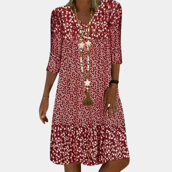 "Elegante Ottilie midi zomerjurk voor dames met V-hals, verfijnde pasvorm, ademende stof en levendige kleuren."