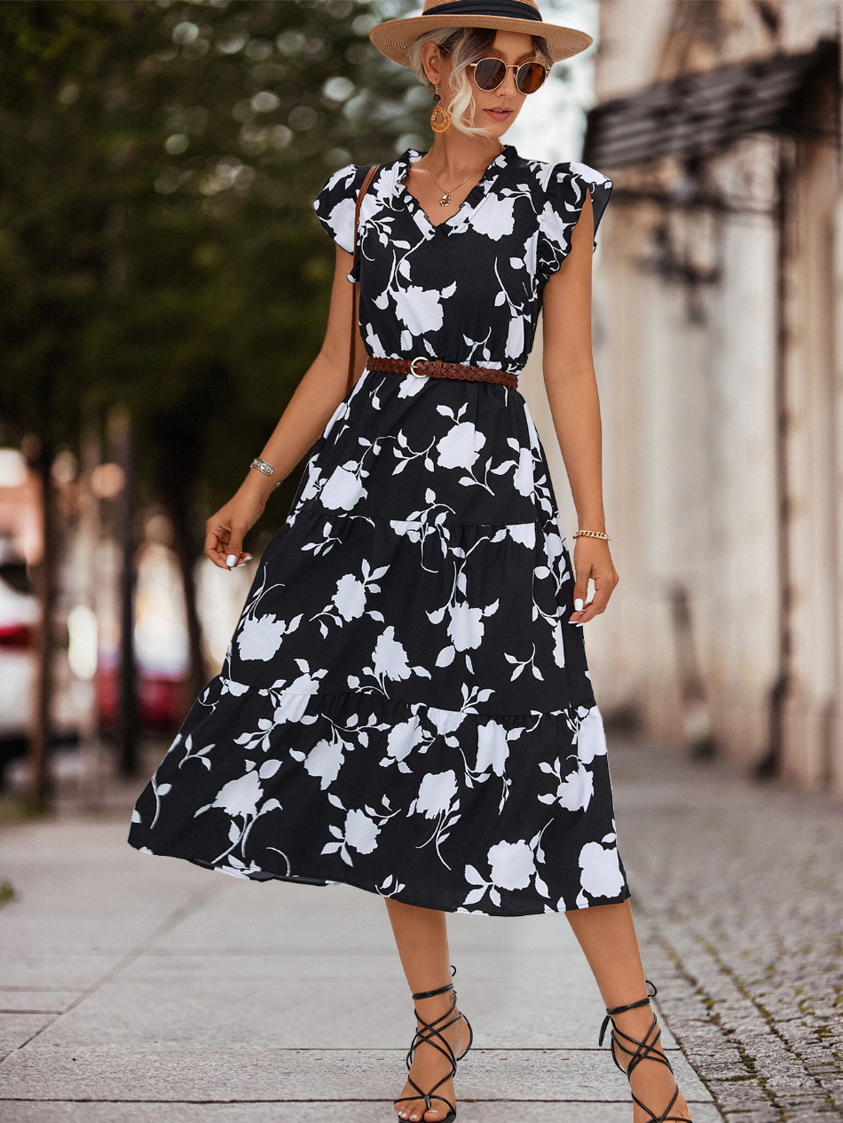 Chique witte dames A-lijn jurk met pofmouwen en kleuraccent, ideaal als feestjurk of elegante zomeroutfit.