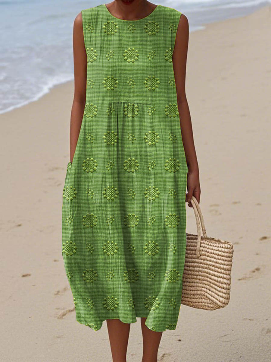 Vrouw draagt een groene vintage jurk met bloemmotief op het strand