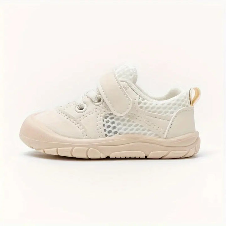 Flexibele babyschoenen in beige, ondersteunt natuurlijke voetbeweging en gezonde voetontwikkeling.