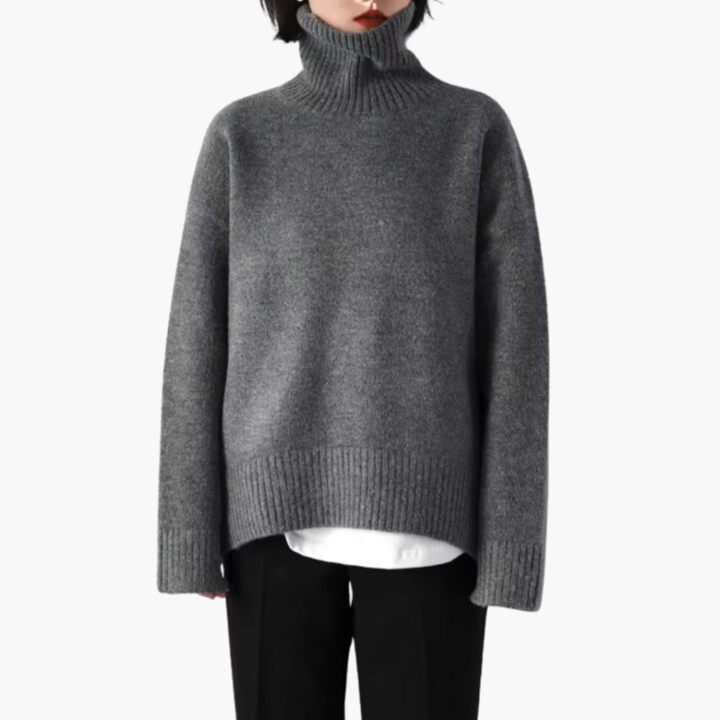 Geribbelde grijze damestrui met turtleneck en lange mouwen, perfect voor herfst/winter. Comfortabele elegante pullover.