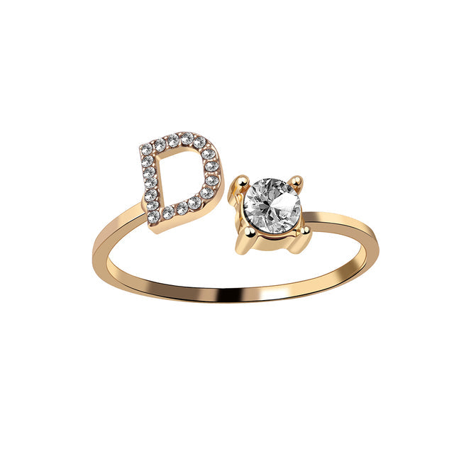 Gouden dames initialenring J, verstelbaar, RVS, minimalistische look.