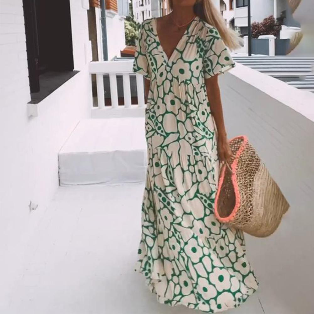 Groene dames maxi jurk met kleurrijke print, korte mouwen, V-hals en elastische stof. Perfecte zomerjurk.