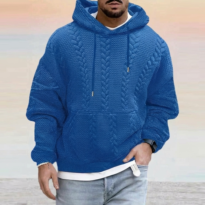 Model draagt een comfortabele heren oversized hoodie, toont relaxte pasvorm en casual streetwear stijl.