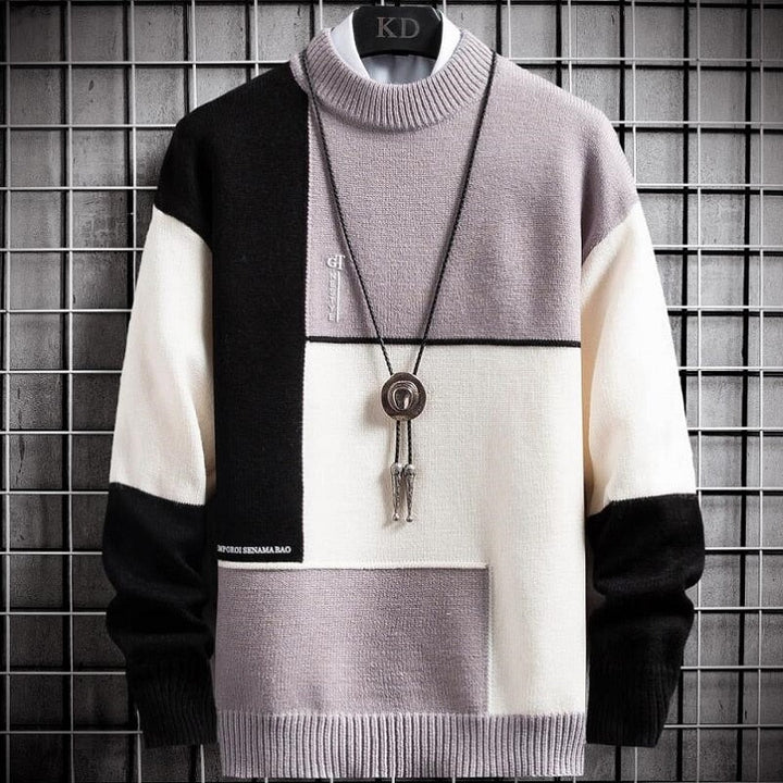 Warme heren sweater met uniek patchwork design. Comfortabele pullover met ronde hals in groen, zwart, lichtpaars.