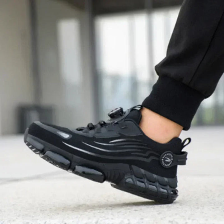 Zijkant van de heren veiligheidssneakers, zwart/grijs, met stalen neus en robuuste antislipzool.